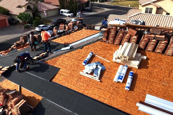 Vero Exteriors crew removing existing tile and worn underlayment on a 32-year-old Mesa roof